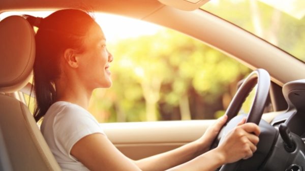 happy woman driving her car